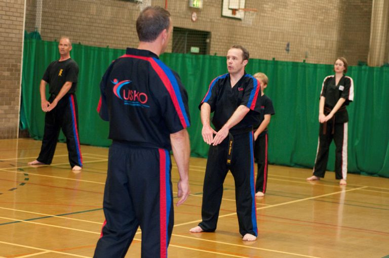 Instructor teaching a class of adult students