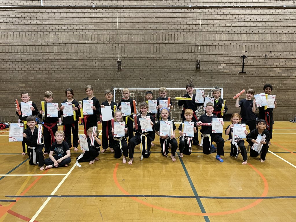 Group of students holding their grading certificates