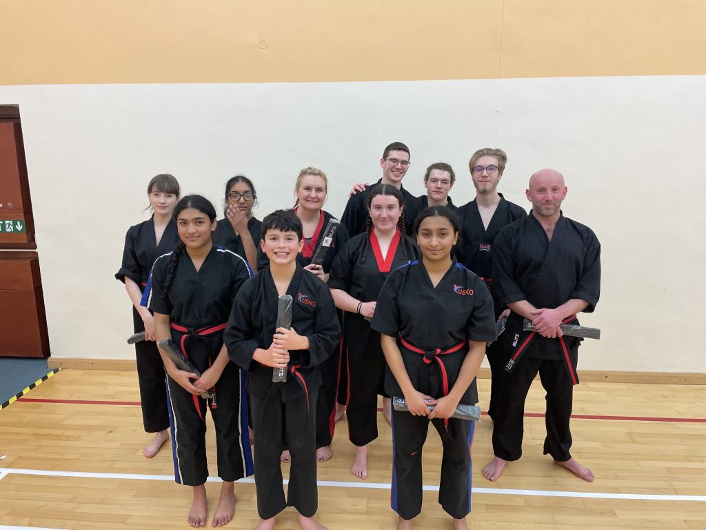 Students and instructors posing in the sports hall