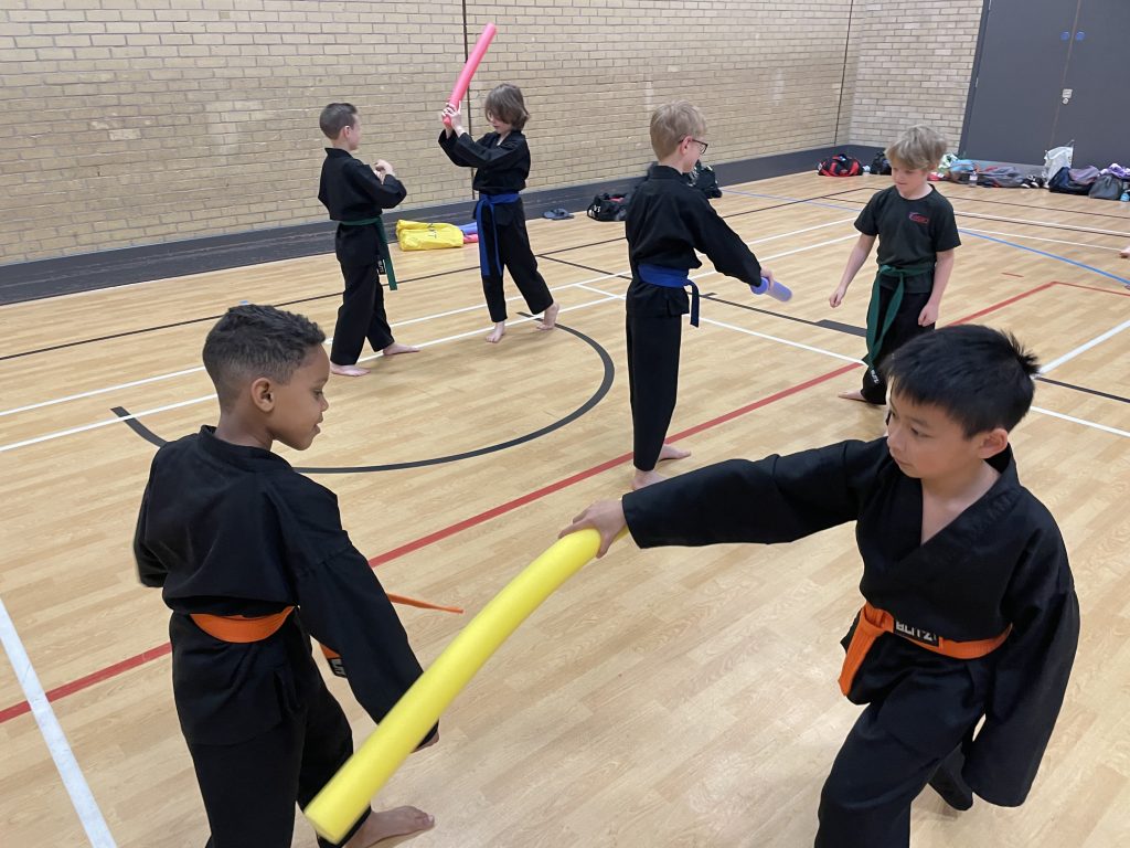 Children training with foam noodles
