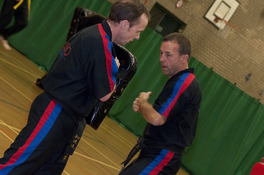 Instructor holding a pad during adult training